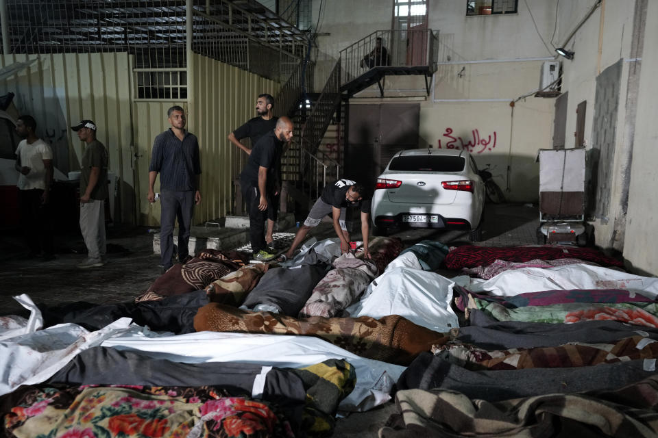 Palestinians check the bodies of their relatives killed in an Israeli bombardment of UNRWA school at Nusseirat refugee camp, in front of the morgue of al-Aqsa Martyrs hospital in Deir al-Balah, central Gaza Strip, early Thursday, June 6, 2024. The Israeli military said that Hamas militants were operating from within the school. (AP Photo/Abdel Kareem Hana)