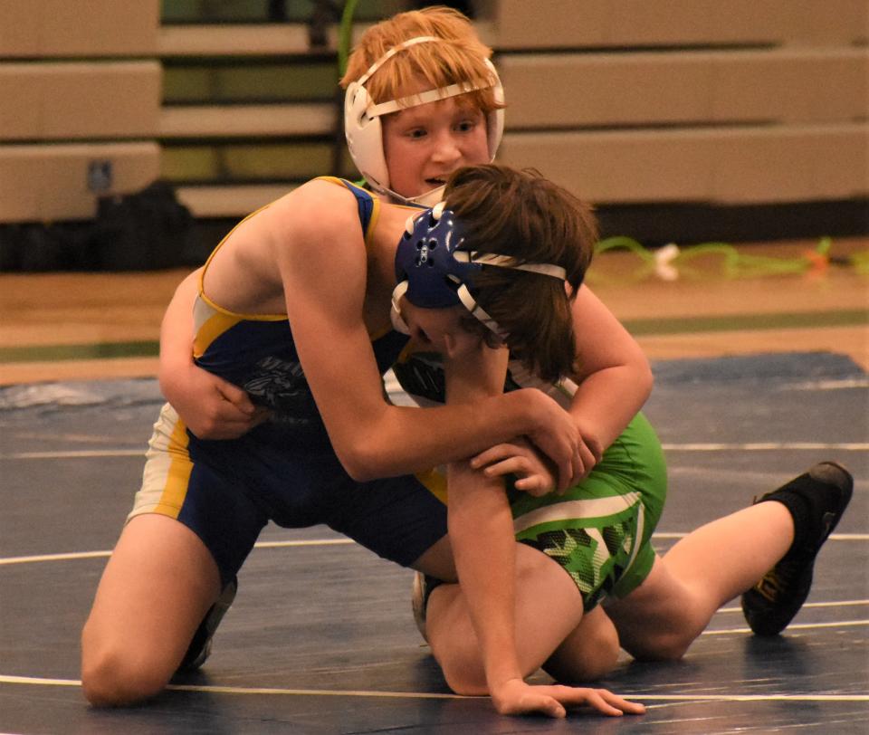 Gunnar Richard, a Herkimer seventh-grader, grapples with Mt. Markham Mustang Landon Youngkrans (oreground) during the 124-pound bout Tuesday.