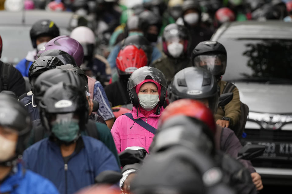 Motorists are stuck in the morning rush hour traffic in Jakarta, Indonesia, Wednesday, Jan. 26, 2022. Indonesian parliament last week passed the state capital bill into law, giving green light to President Joko Widodo to start a $34 billion construction project this year to move the country's capital from the traffic-clogged, polluted and rapidly sinking Jakarta on the main island of Java to jungle-clad Borneo island amid public skepticism. (AP Photo/Dita Alangkara)