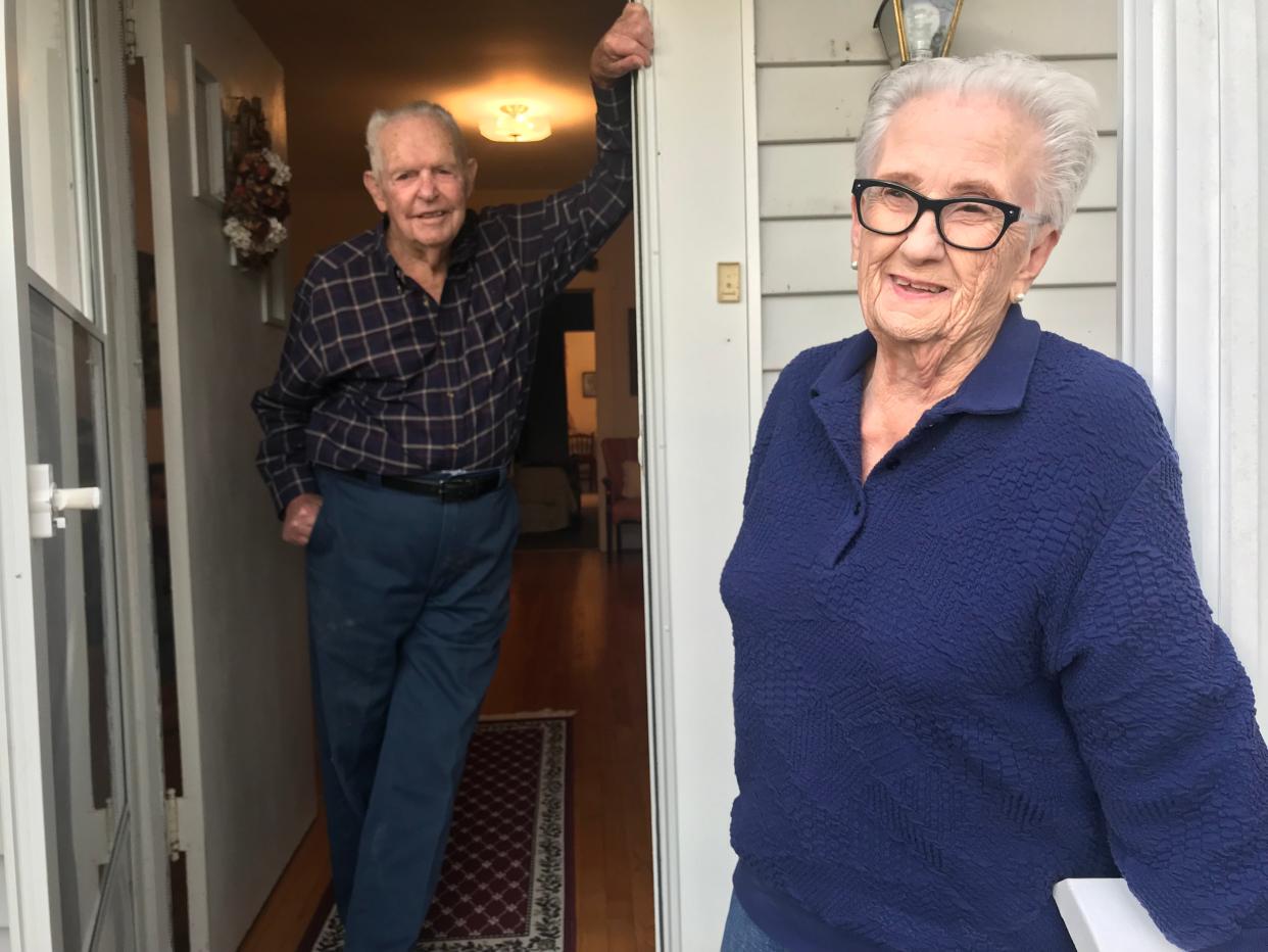 Cecil Whiteside, 99, and wife Letha Lou, 90, stand on the front porch of their home in Hampshire, where they have operated a farm since the 1950s.