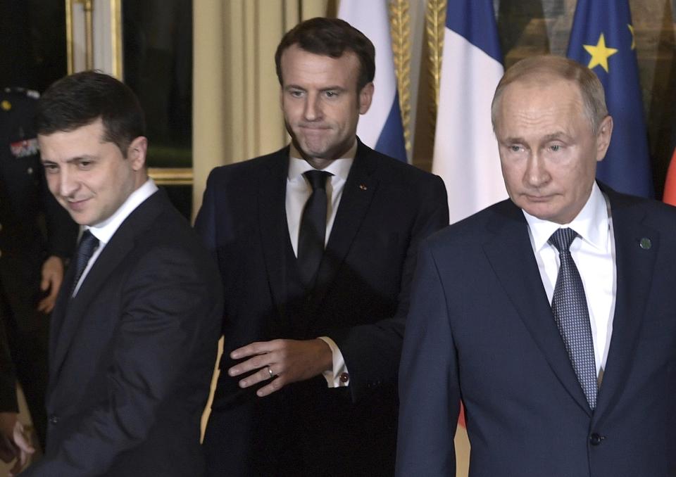 FILE - French President Emmanuel Macron, centre, Russian President Vladimir Putin, right, and Ukrainian President Volodymyr Zelenskiy, left, arrive for a working session at the Elysee Palace, in Paris, France, Monday, Dec. 9, 2019. The implementation of the 2015 peace agreement for eastern Ukraine has stalled, and France and Germany sought to revive it to help defuse soaring tensions. (Alexei Nikolsky, Sputnik, Kremlin Pool Photo via AP)