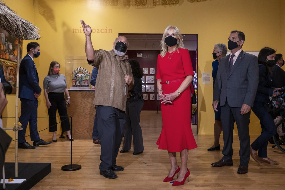 Chief Curator Cesareo Moreno leads Jill Biden through the Day of the Dead Exhibit at the National Museum of Mexican Art. - Credit: AP