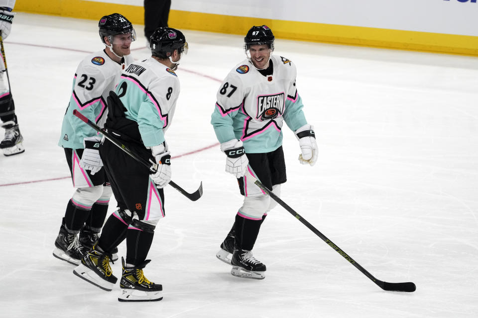 Metropolitan Division's Sidney Crosby, of the Pittsburg Penguins (87) laughs with Alex Ovechkin, of the Washington Capitals (8) and Adam Fox, of the New York Rangers (23) during the NHL All Star hockey game, Saturday, Feb. 4, 2023, in Sunrise, Fla. (AP Photo/Marta Lavandier)