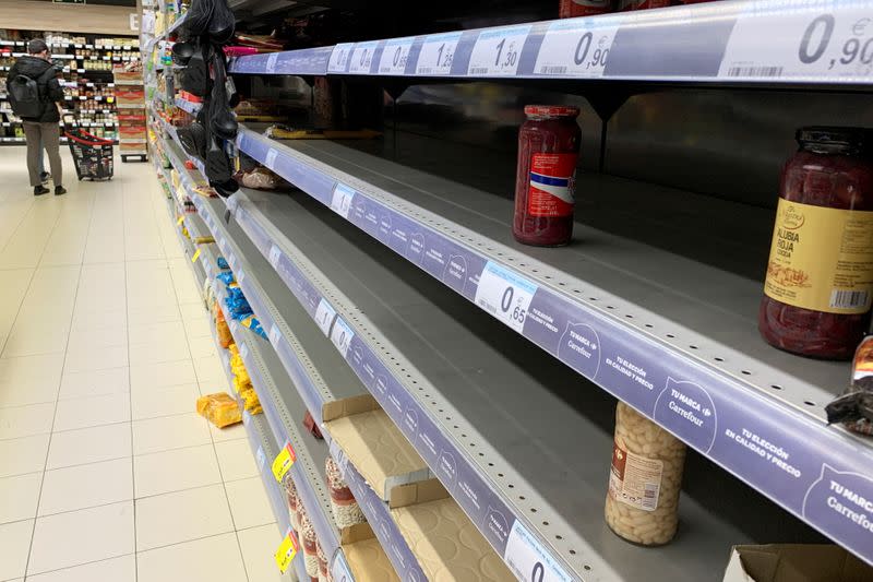 Almost empty shelves are seen inside a supermarket in central Madrid