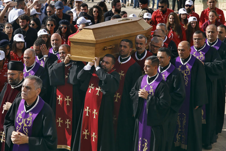 Clergymen carry the coffin of former Maronite Patriarch Cardinal Mar Nasrallah Boutros Sfeir, during his funeral Mass, at the seat of the Maronite Church, in the village of Bkirki, north of Beirut, Lebanon, Thursday, May 16, 2019. Sfeir, who served as spiritual leader of Lebanon's largest Christian community through some of the worst days of the country's 1975-1990 civil war, died Sunday. (AP Photo/Bilal Hussein)