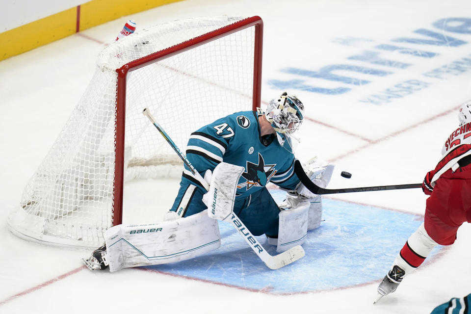 San Jose Sharks goaltender James Reimer (47) defects a shot by Carolina Hurricanes right wing Andrei Svechnikov, right, during the third period of an NHL hockey game in San Jose, Calif., Friday, Oct. 14, 2022. (AP Photo/Godofredo A. Vásquez)