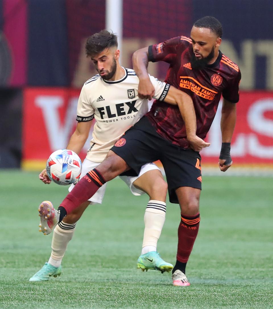 Atlanta United defender Anton Walkes battles Los Angeles FC forward Diego Rossi for the ball during the second half of an MLS soccer match on Sunday, Aug. 15, 2021, in Atlanta. (Curtis Compton/Atlanta Journal-Constitution via AP)