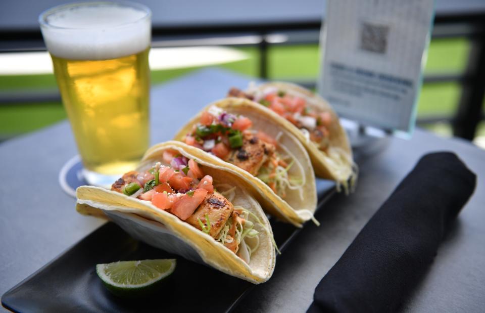 One of the items on the menu at the PopStroke restaurant is blackened mahi tacos, paired with a draft PopStroke lager.