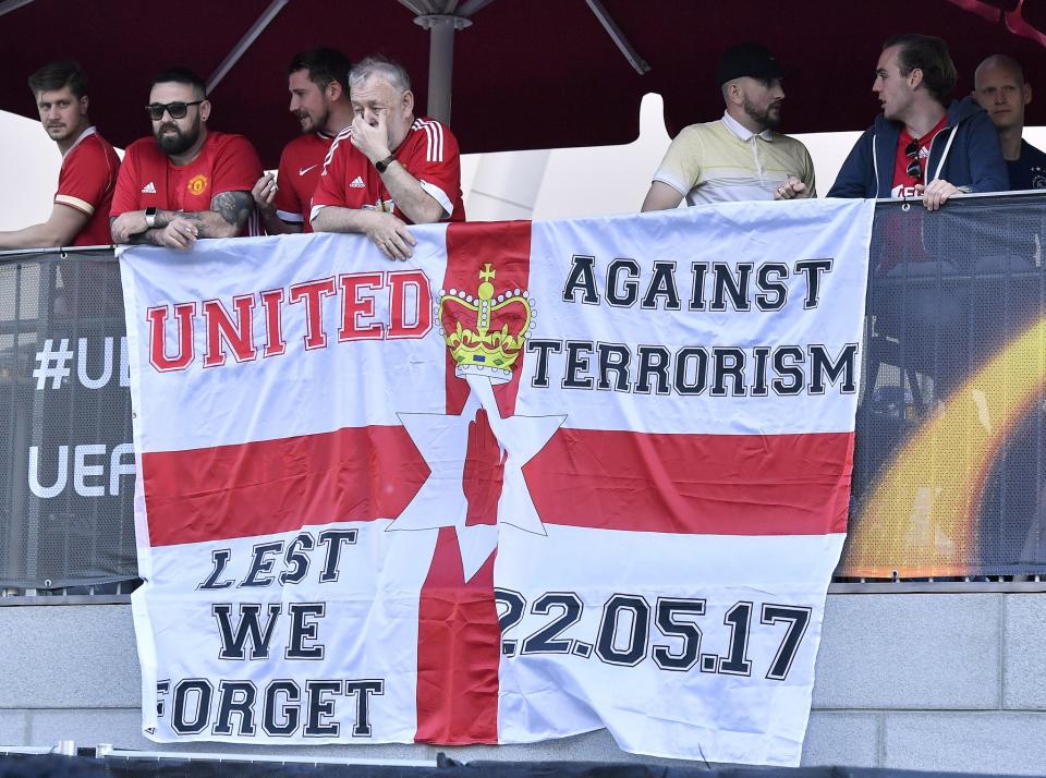 <p>Supporters stay behind a flag outside the stadium prior to the soccer Europa League final between Ajax Amsterdam and Manchester United at the Friends Arena in Stockholm, Sweden, Wednesday, May 24, 2017. (AP Photo/Martin Meissner) </p>