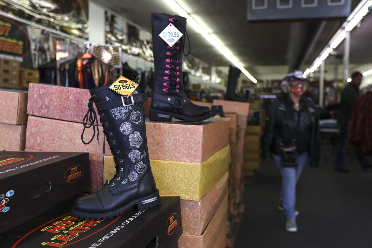 Boots are displayed in a shop along Main Street in Daytona, FL during Bike Week on March 5, 2021. (Sam Thomas/Orlando Sentinel)