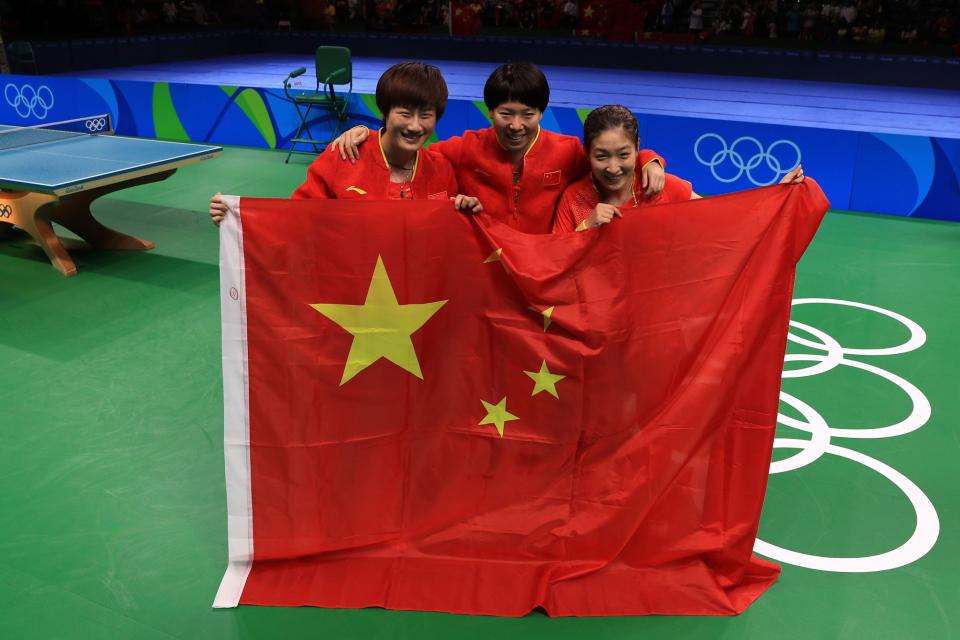 <p>Xiaoxia Li, Shiwen Liu and Ning Ding of China celebrate winning gold in the Women’s Team Gold Medal Team Match between China and Germany on Day 11 of the Rio 2016 Olympic Games at Riocentro – Pavilion 3 on August 16, 2016 in Rio de Janeiro, Brazil. (Photo by Mike Ehrmann/Getty Images) </p>