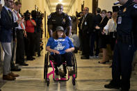 <p>A demonstrator in a wheelchair protesting cuts to Medicaid is led from the office of Senate Majority Leader Mitch McConnell by a U.S. Capitol police officer at the Russell Senate Office building in Washington, D.C., U.S., on Thursday, June 22, 2017. (Photo: Andrew Harrer/Bloomberg via Getty Images) </p>