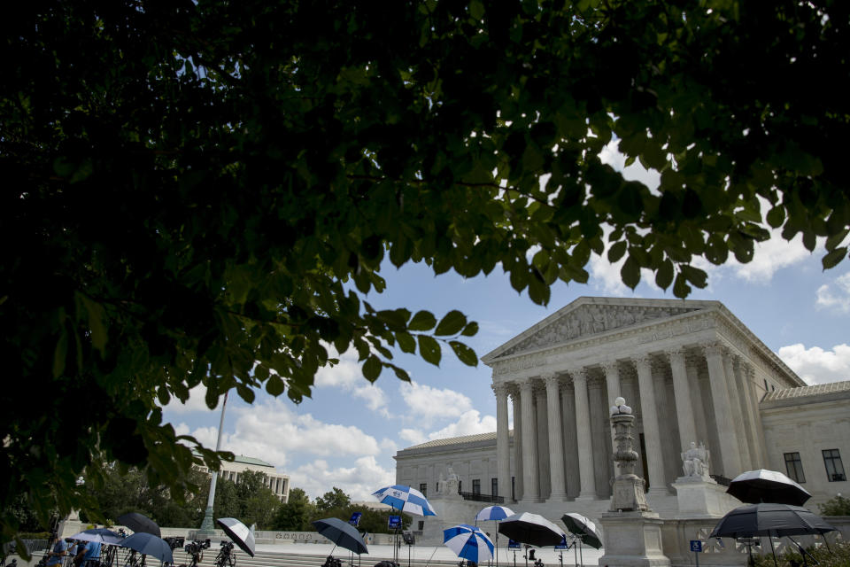 Members of the media set up outside the Supreme Court, Thursday, July 9, 2020, in Washington. The Supreme Court ruled Thursday that the Manhattan district attorney can obtain Trump tax returns while not allowing Congress to get Trump tax and financial records, for now, returning the case to lower courts. (AP Photo/Andrew Harnik)