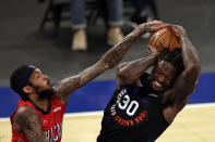 New York Knicks forward Julius Randle, right, battles for the ball with New Orleans Pelicans forward Brandon Ingram, left, during the second half of an NBA basketball game Sunday, April 18, 2021, in New York. (AP Photo/Adam Hunger, Pool)