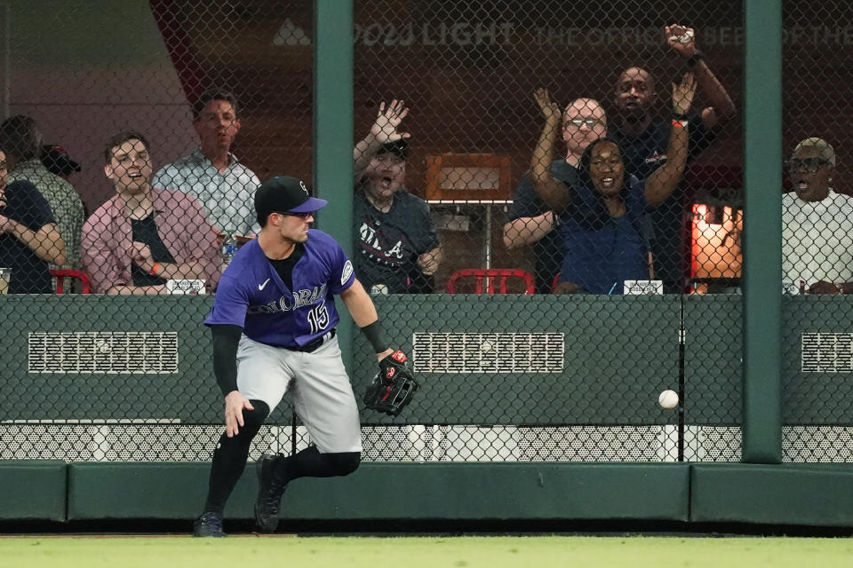 Colorado Rockies right fielder Randal Grichuk can't reach a ball hit for a double by Atlanta Braves' Eddie Rosario during the third inning of a baseball game Tuesday, Aug. 30, 2022, in Atlanta. (AP Photo/John Bazemore)