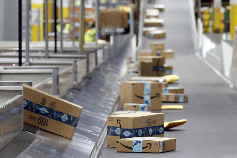 FILE - Amazon packages move along a conveyor at an Amazon warehouse facility on Dec. 17, 2019, in Goodyear, Ariz. July sales events have become a seasonal revenue driver for the retail industry since Amazon launched its first Prime Day back in 2015. (AP Photo/Ross D. Franklin, File)