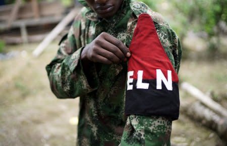 A rebel of Colombia's Marxist National Liberation Army (ELN) shows his armband while posing for a photograph, in the northwestern jungles, Colombia August 31, 2017. REUTERS/Federico Rios