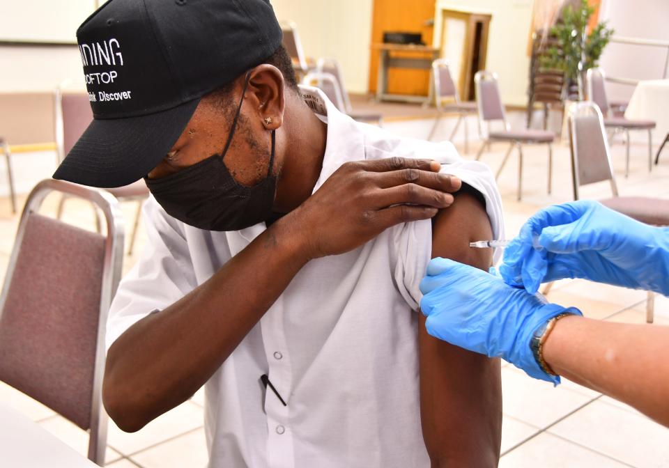 Sean Harris gets a COVID-19 vaccine in August 2021 at the Greater Allan Chapel AME Church in Melbourne.