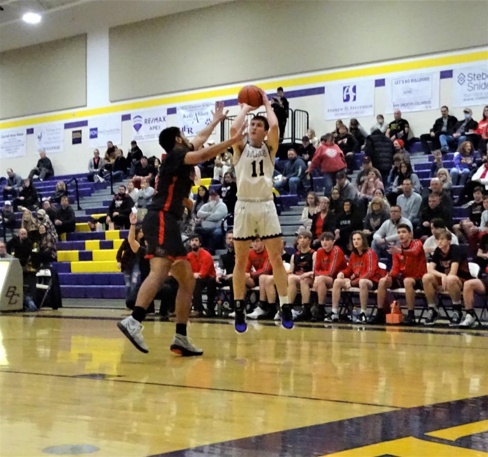 Bloom-Carroll's Jared Rose shoots a jumper over Liberty Union's Jaden Smith in the first half of the Bulldogs' 61-29 Mid-State League-Buckeye Division win Friday night at Tom Petty Gymnasium.