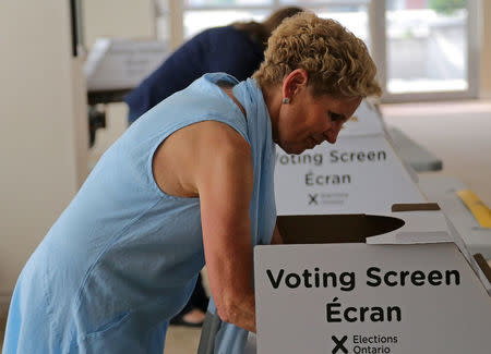 Ontario Premier Kathleen Wynne fills out her ballot while voting at a polling station during provincial election in Toronto, Ontario, Canada June 7, 2018. REUTERS/Chris Helgren