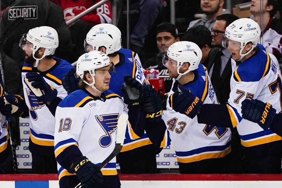 St. Louis Blues' Robert Thomas (18) is congratulated for his goal against the New Jersey Devils during the third period of an NHL hockey game Thursday, Jan. 5, 2023, in Newark, N.J. The Blues won 5-3. (AP Photo/Frank Franklin II)