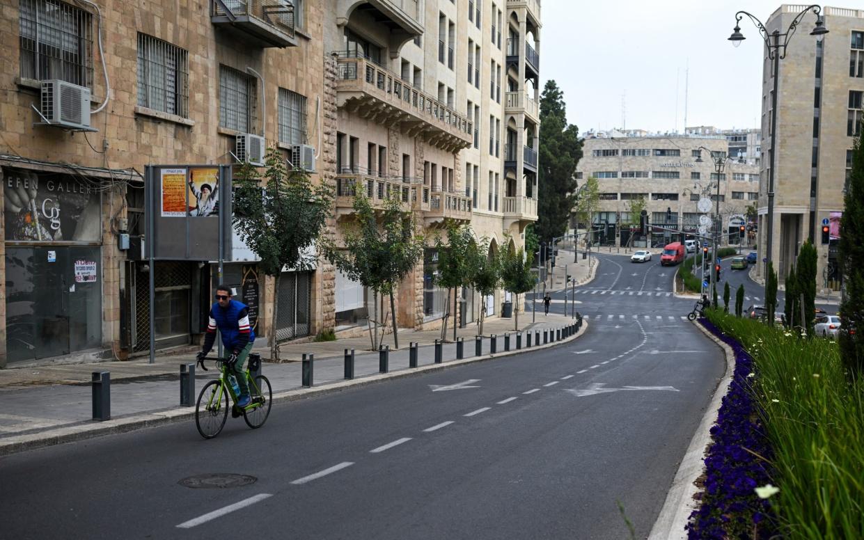 A cyclist rides in Jerusalem on Sunday morning