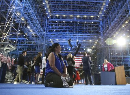 U.S. Democratic presidential nominee Hillary Clinton supporter Maria Rosero of Seattle sits on the floor after the election night rally in New York, U.S., November 9, 2016. REUTERS/Adrees Latif
