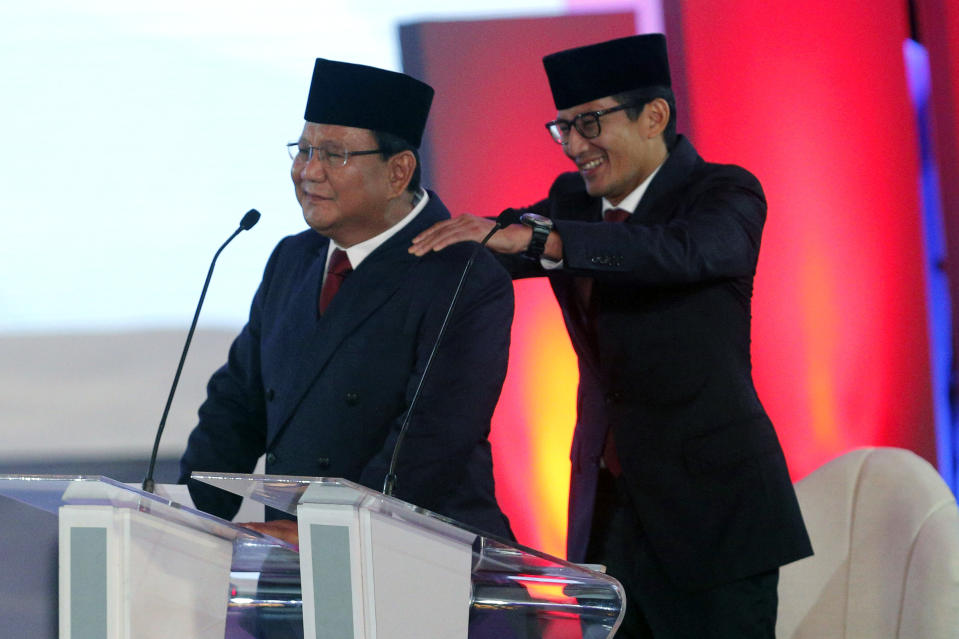 Indonesian presidential candidate Prabowo Subianto delivers his speech, with running mate Sandiaga Uno, right, during a televised debate in Jakarta, Indonesia, Thursday, Jan. 17, 2019. Indonesia is gearing up to hold its presidential election on April 17 that will pit in the incumbent against the former general.(AP Photo / Tatan Syuflana)