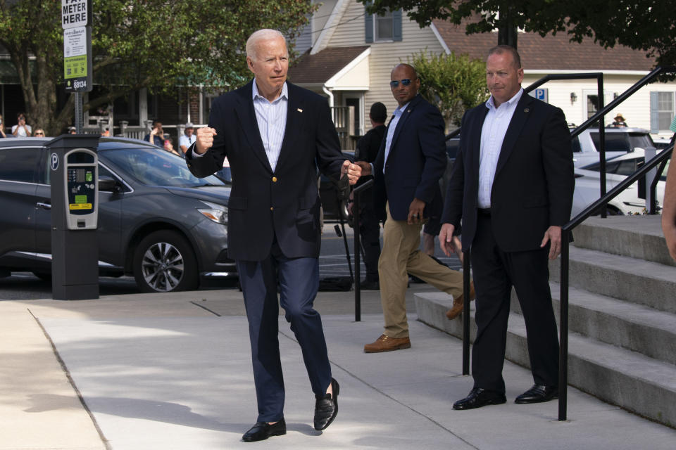 President Joe Biden reacts when asked how he was feeling as he leaves St. Edmund Roman Catholic Church in Rehoboth Beach, Del., after attending a Mass, Saturday, June 18, 2022. Bystanders cheered as he was asked how he was feeling. He smiled, and took three hops forward, making a jump-rope motion with his hands. (AP Photo/Manuel Balce Ceneta)