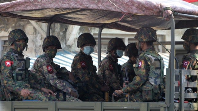 Soldiers are transported in a truck in Myanmar