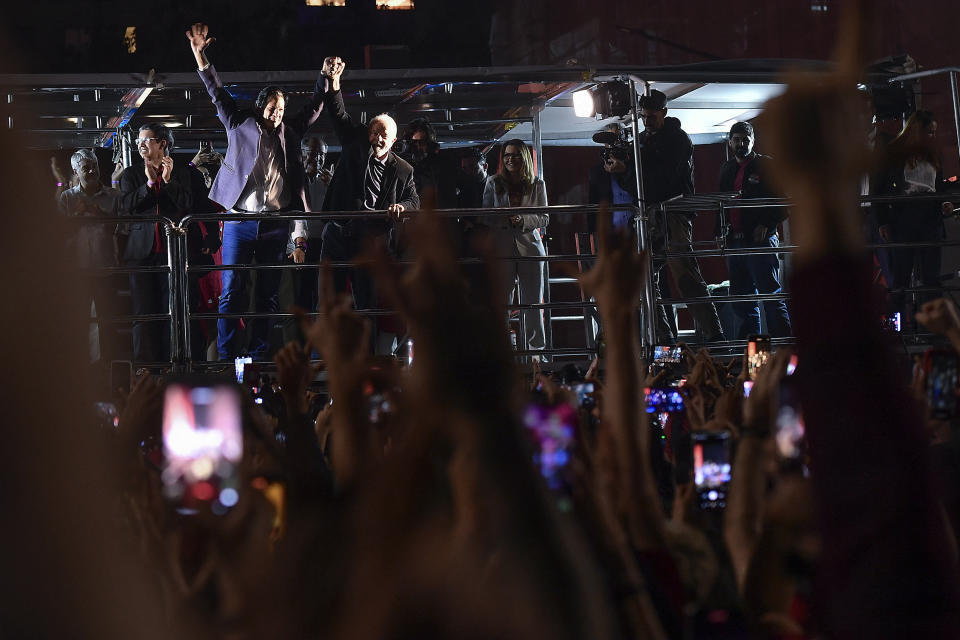 Former Brazilian President Luiz Inacio Lula da Silva, right, who is running for president again, and Workers' Party gubernatorial candidate Fernando Haddad celebrate with supporters after general election polls closed in Sao Paulo, Brazil, Sunday, Oct. 2, 2022.(AP Photo/Matias Delacroix)