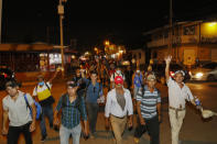 Migrants walk along a highway in hopes of reaching the distant United States, as they depart San Pedro Sula, Honduras, Wednesday, Sept. 30, 2020. Hundreds of migrants have begun walking from this northern Honduras city toward the Guatemala border testing a well-trod migration route now in times of the new coronavirus. (AP Photo/Delmer Martinez)