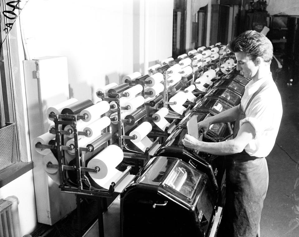 An Associated Press staffer reads copy from the election tabulator, Nov. 1936. (AP Photo)