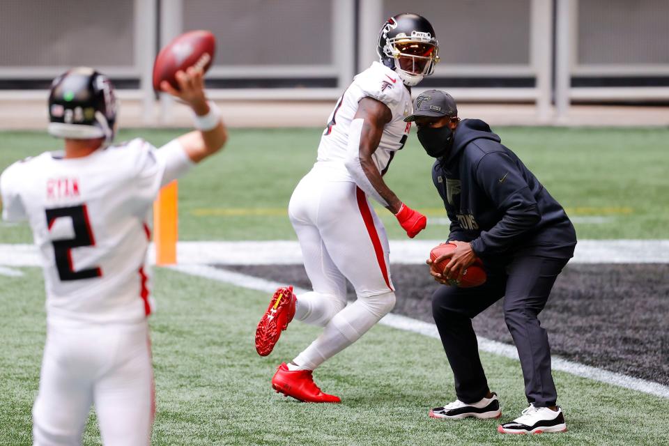 ATLANTA, GEORGIA - NOVEMBER 08: Julio Jones #11 of the Atlanta Falcons warms up with interim head coach Raheem Morris before the game against the Denver Broncos at Mercedes-Benz Stadium on November 08, 2020 in Atlanta, Georgia. (Photo by Kevin C. Cox/Getty Images)