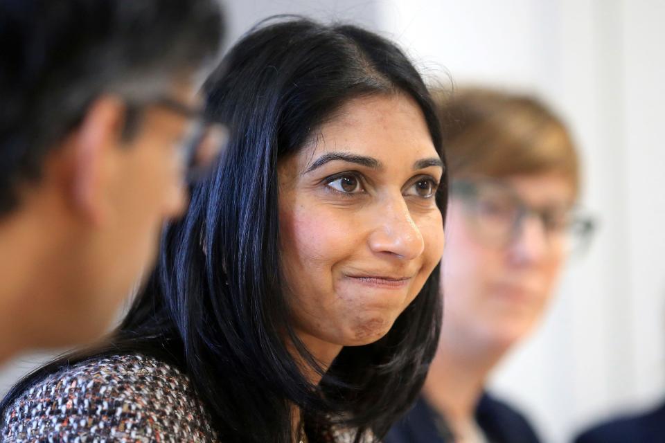 Britain's Prime Minister Rishi Sunak, left, and Britain's Home Secretary Suella Braverman, center, visit the National Society for the Prevention of Cruelty to Children (NSPCC), in Leeds, northern England, Monday, April 3, 2023. (Lindsey Parnaby/Pool Photo via AP)