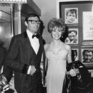 <p>Adam West and Jill St. John smile and hold hands at the premiere of director John Huston’s film, “The Bible,” Oct. 1966.’ They are standing in front of a billboard advertising the film. (Photo: Max B. Miller/Fotos International/Getty Images) </p>