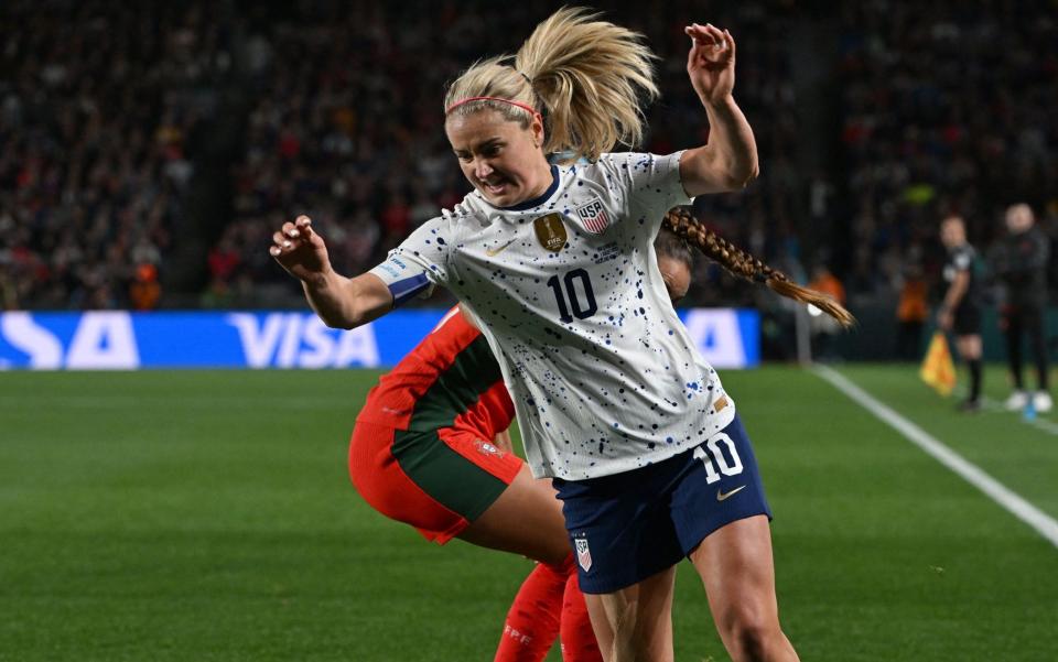 Lindsey Horan (R) fights for the ball during the Australia and New Zealand 2023 Women's World Cup Group E football match between Portugal and the United States at Eden Park in Auckland