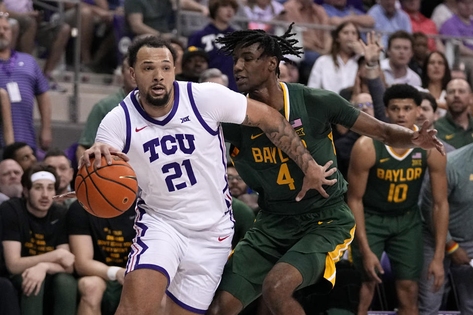 TCU forward JaKobe Coles works to the basket against Baylor's Ja'Kobe Walter (4) in the first half of an NCAA college basketball game in Fort Worth, Texas, Monday, Feb. 26, 2024. (AP Photo/Tony Gutierrez)