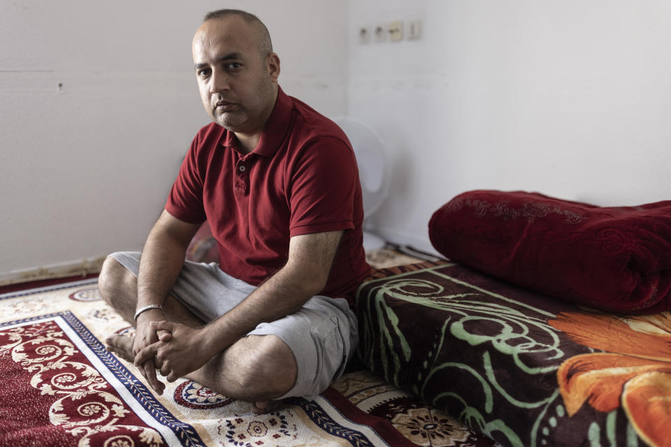 Afghanistan's Abdul Wali poses in his apartment in Strasbourg, eastern France, Sunday, Sept. 4, 2021. Wali took the last bus out of a huge makeshift migrant camp in the northern French port of Calais. His government bus took him to Strasbourg. “Now, I’m so happy to be here,” he said. “You’re not scared at night” like in the migrant camp nicknamed The Jungle. “You have your job. You have your work, you come back home. You pay your rent. You are a normal person.” (AP Photo/Jean-Francois Badias)