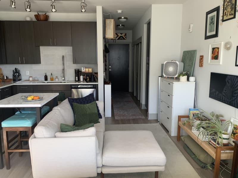 A sectional in the living room space of a studio apartment.