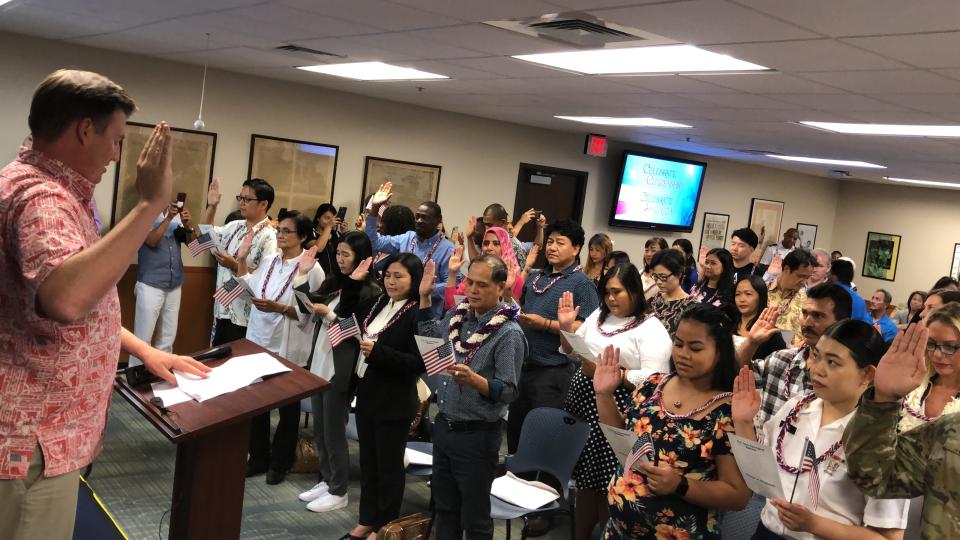 Led by a United States Citizenship and Immigration Services (USCIS) official, 44 newly minted US citizens from 16 countries recite the Pledge of Allegiance in Honolulu, Hawaii on 24 April 2019. PHOTO: Nicholas Yong/Yahoo News Singapore 