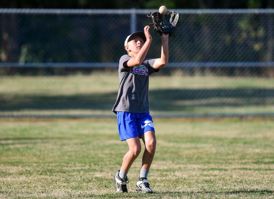 Sajen Haas (#7) makes a catch in the outfield during Little League practice on Monday, August 1, 2022, at Cherry Rock Park in Sioux Falls.