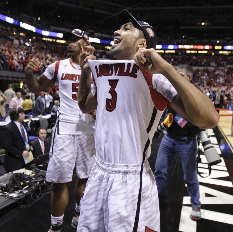 Louisville's Peyton Siva (#3) and Chane Behanan, wearing injured Kevin Ware's jersey, celebrate after the Cards defeat Duke to advance to the Final Four.
Mar. 31, 2013