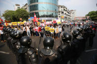 Anti-coup protesters face a row of riot police in Yangon, Myanmar Friday, Feb. 19, 2021. In the month since Feb. 1 coup, the mass protests occurring each day are a sharp reminder of the long and bloody struggle for democracy in a country where the military ruled directly for more than five decades. (AP Photo)