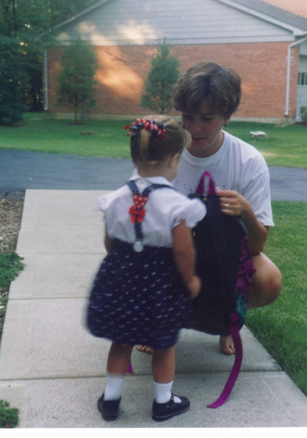 Kerry Daugherty helps her daughter, Jillian, get ready for school in this undated photo.