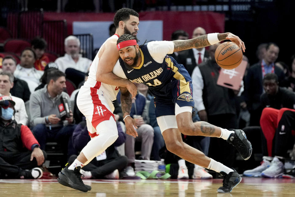New Orleans Pelicans forward Brandon Ingram, right, dribbles as Houston Rockets guard Fred VanVleet defends during the first half of an NBA basketball game Wednesday, Jan. 31, 2024, in Houston. (AP Photo/Eric Christian Smith)