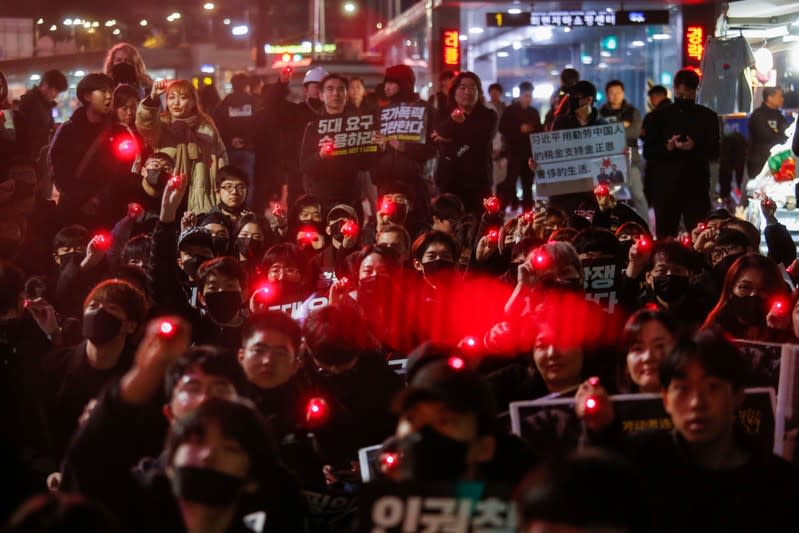 Students and young people point laser pens during a demonstration to support Hong Kong pro-democracy protesters in Seoul