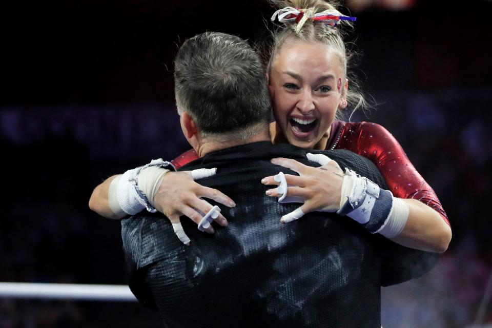 Oklahoma's Audrey Davis hugs associate head coach Lou Ball after competing on the bars during the University of Oklahoma's women's gymnastics NCAA Regional at Lloyd Noble Center in Norman, Okla., Saturday, April 1, 2023. 