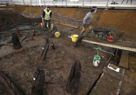 Archaeologists from the University of Cambridge Archaeological Unit, uncover Bronze Age wooden houses, preserved in silt, from a quarry near Peterborough, Britain, January 12, 2016. REUTERS/Peter Nicholls