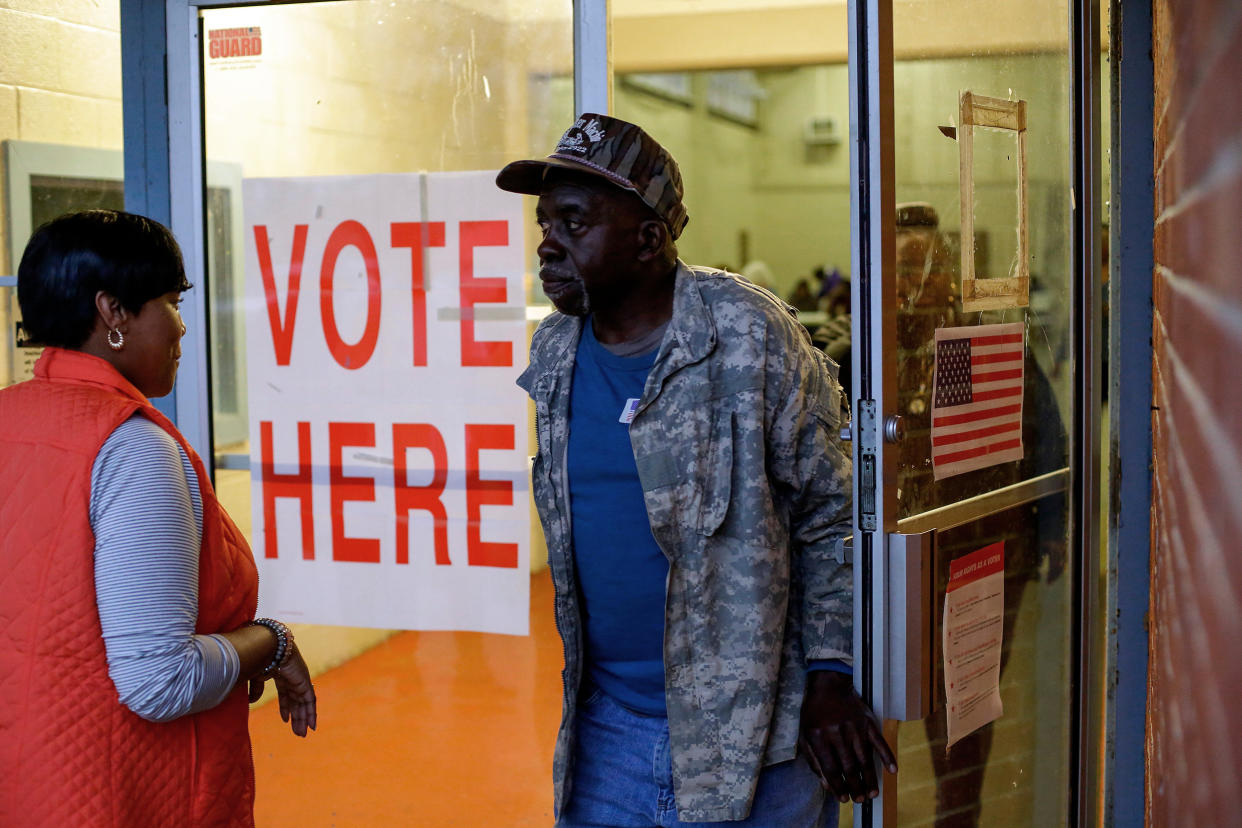 Voters exit a polling station at the National Guard Military Base during the presidential primary in Camden, Ala., (Joshua Lott / AFP via Getty Images file)